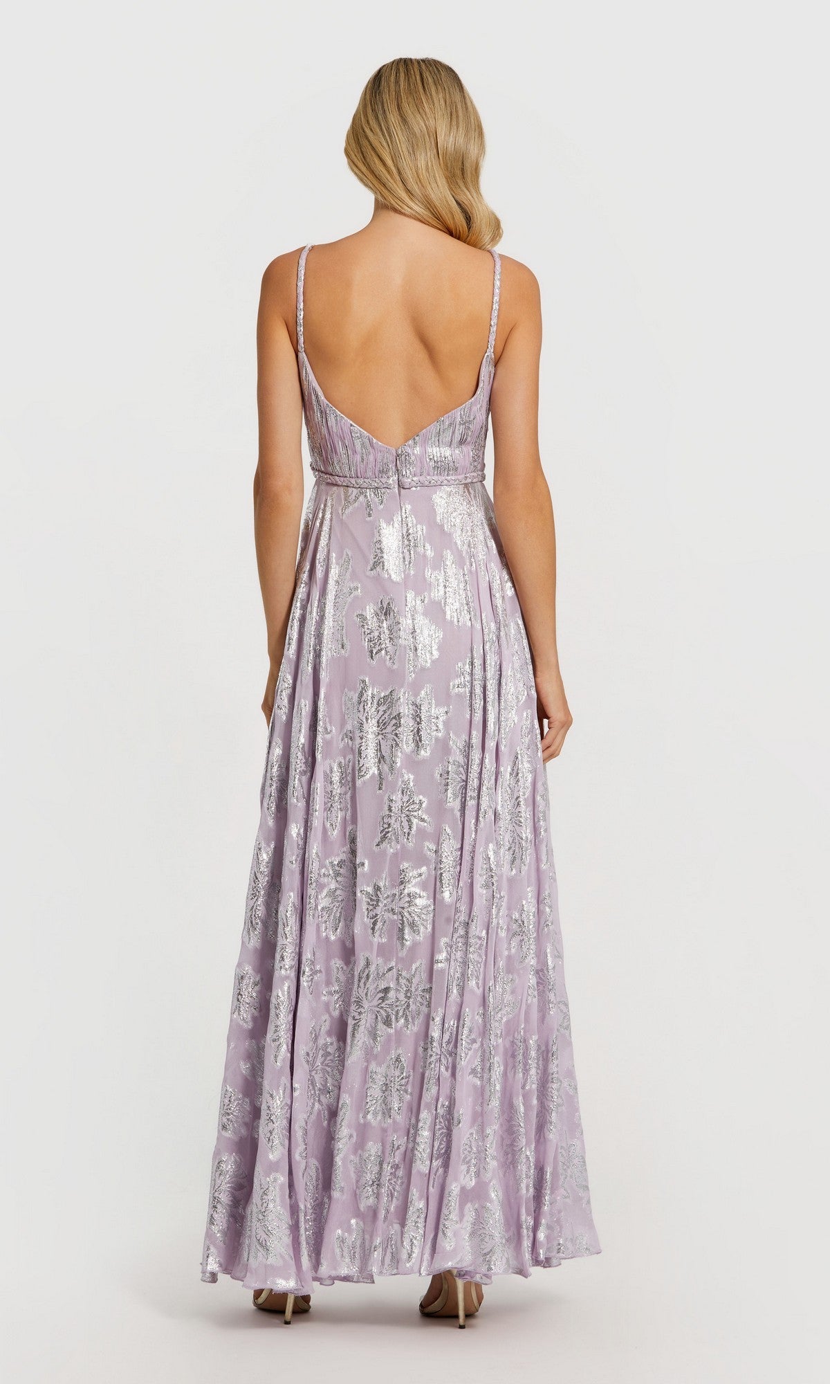 A woman shown from the back against a plain white background wears the Mac Duggal 9310, a floor-length sleeveless lilac formal dress adorned with silver sequin patterns.